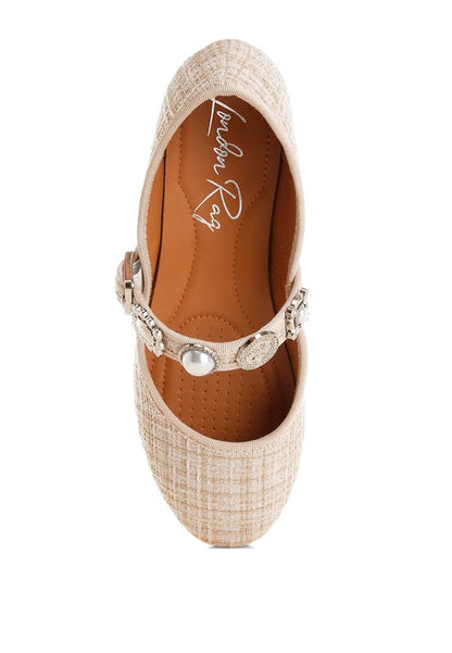 Top view of beige Noyama Tweed Mary Jane flat displaying the charm embellishments, buckle strap, and classic round toe design.