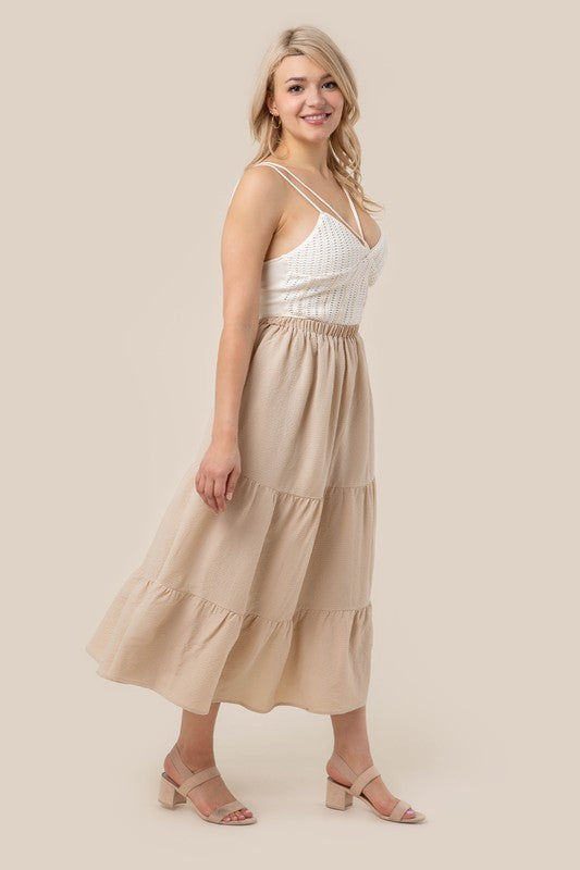 Tiered maxi skirt with elastic waistband in beige. Flowy silhouett, lined for full coverage.