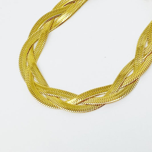 Detail of Braided Herringbone Chain Bracelet highlighting braided herringbone links and gold finish.