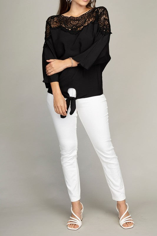 Feminine black blouse with lace trim, three-quarter dolman sleeves, and a tie detail.