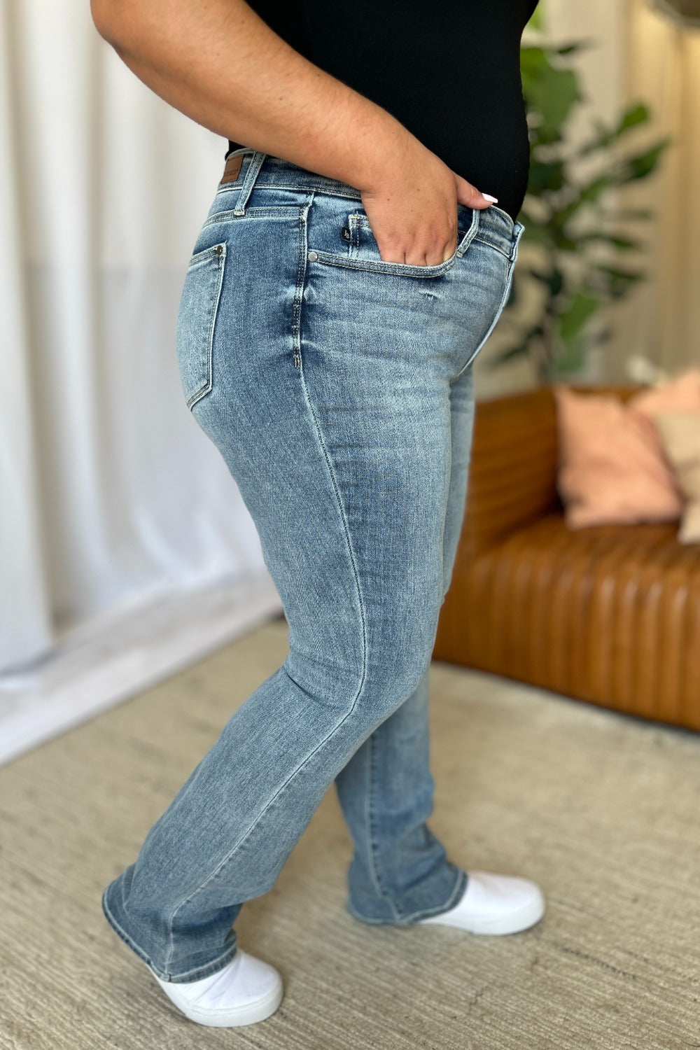 Medium Rise Bootcut Jeans by Judy Blue in light wash. Flattering medium rise, slight flare silhouette, moderate stretch for all-day comfort. Perfect for pairing with boots or heels.