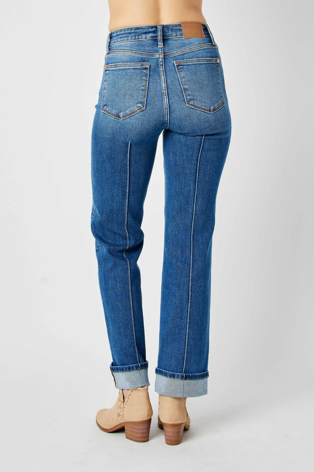 Medium wash high-waist straight-leg jeans with front seam detail and moderate stretch.