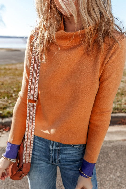 Evangeline Slim Fit Sweater with mock neck and bold contrast edges in pumpkin and purple