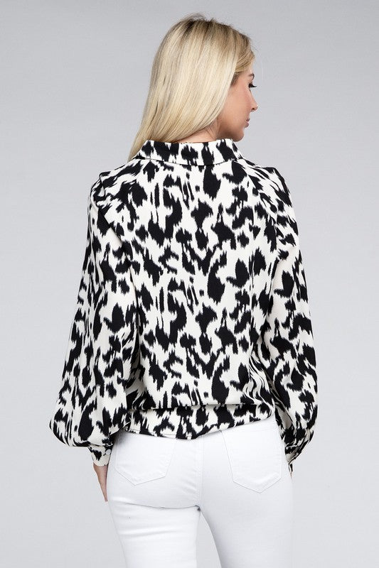 Black and white animal print collared shirt with long sleeves and a relaxed drop-shoulder design.