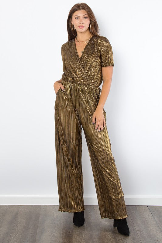 Gold Foil Accent Jumpsuit features a V-neck, short sleeves, pleats, foil details, wide-leg, and pockets.