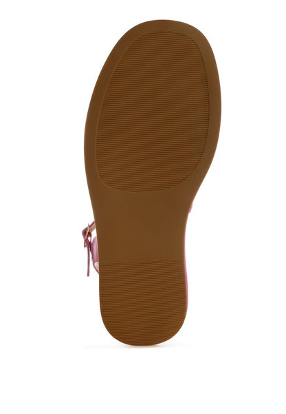 Bottom view of pink woven raffia flatform sandals showing textured rubber sole for grip and durability.