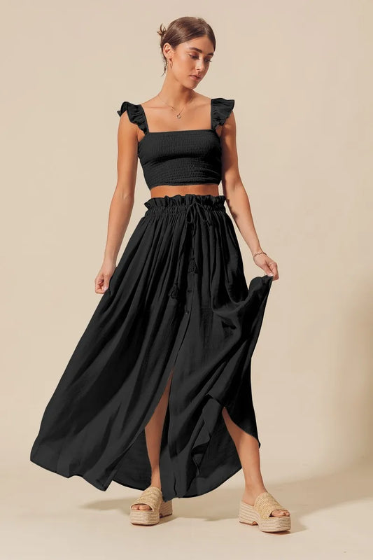 Full body front view of model in Kora Smocked Top and Flowy Black Maxi Skirt Set, styled with sandals for a breezy summer look.
