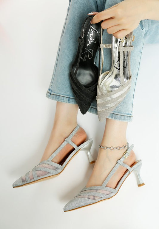 Model wearing Silver Daldra Kitten Heel Slingback Sandals with glitter finish and pointed toe