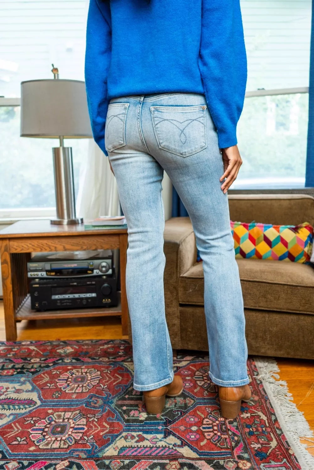 Back view of Misha Mid Rise Thermal Bootcut Jeans showing light wash denim.