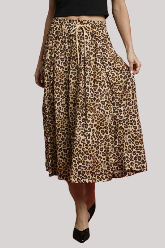 Woman wearing Nala leopard midi skirt with drawstring waist.