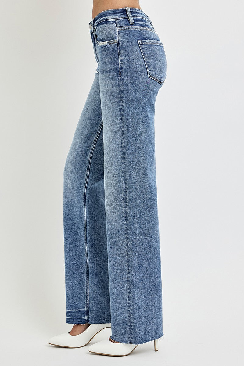 Risen Dana High Rise Straight Leg Jeans in medium wash, featuring a flattering high-waisted fit, slightly stretchy fabric, raw hem, and versatile straight-leg silhouette.