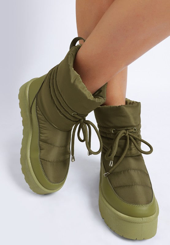 Model front angle pose in khaki Pacos Snow Boots with lace-up detail.