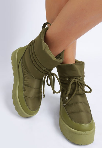 Model front angle pose in khaki Pacos Snow Boots with lace-up detail.