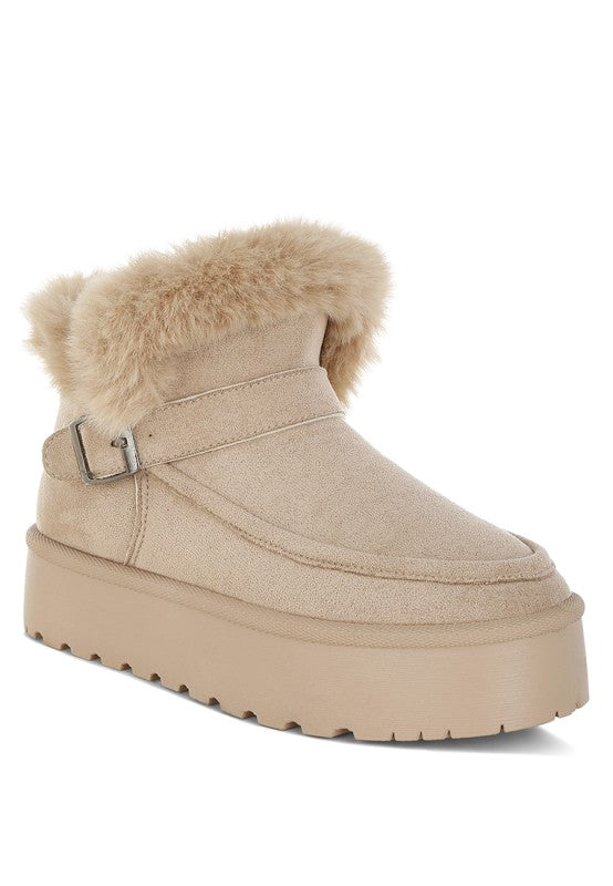 Beige Linka Snow Boots with faux fur collar, flatform sole, and pin buckle strap detail.
