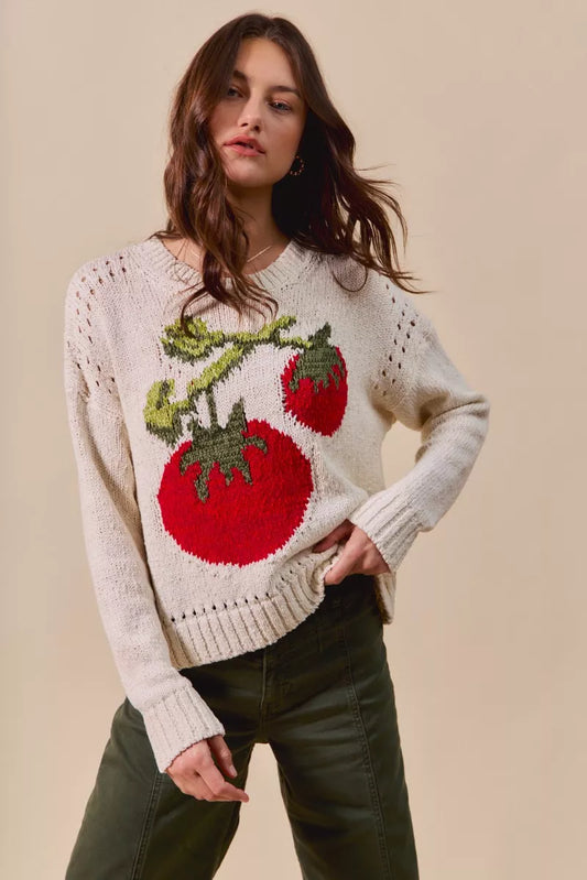 Model wearing Tara Tomato Sweater, cream knit with playful tomato design and round neckline