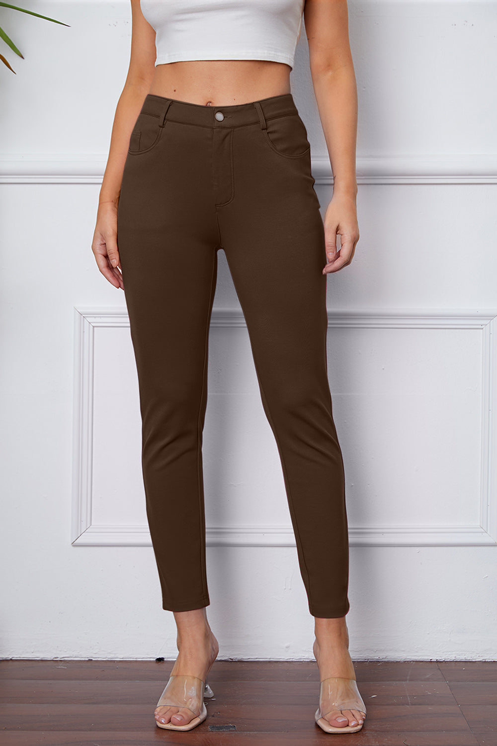 Coffee Brown stretchy high-waisted pants feature pockets, a zip fly, and belt loops. 