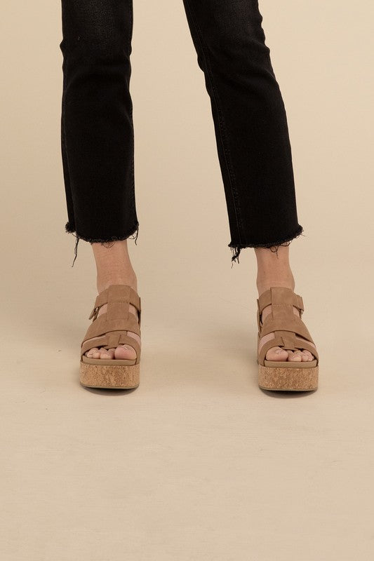 Coffee-colored platform wedge sandals with a buckle closure and 1.5" heel.