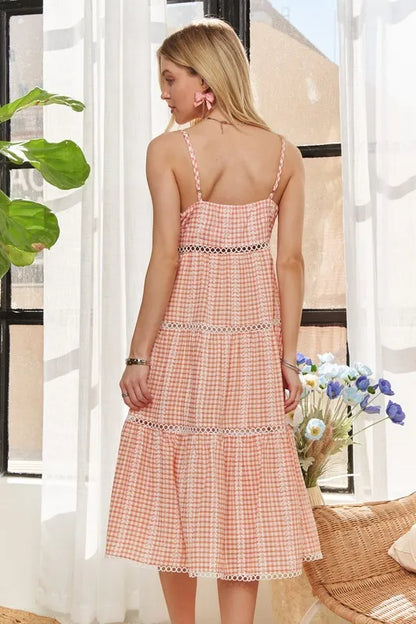 Emilia peach tiered gingham dress with frill accents, fully lined body, and slightly stretchy fabric.