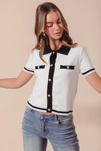 Front view of model in Novah Sweater Shirt Top with rolled sleeves, showing black trim and classic button design