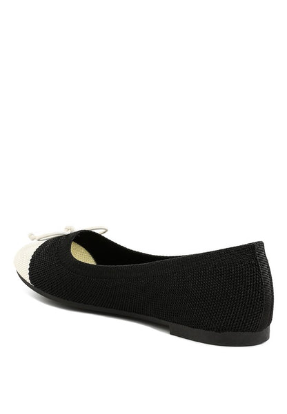 Back side angle view of Rosario Two Tone Ballerinas in black and white with flat heel