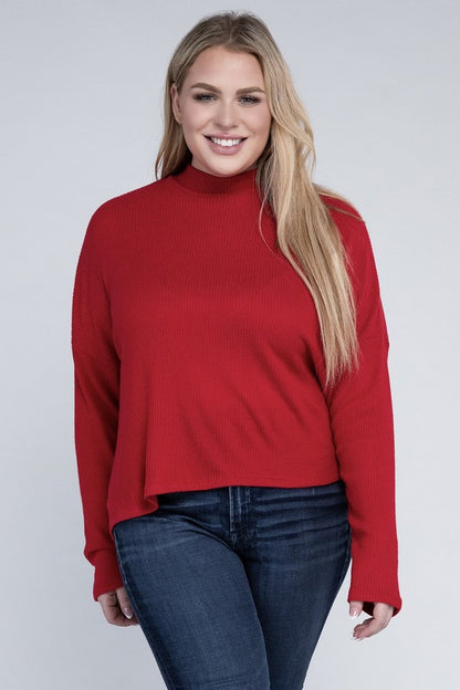 Plus size model wearing Raya Curvy Plus Drop Shoulder Top in red with mock neck, front view.