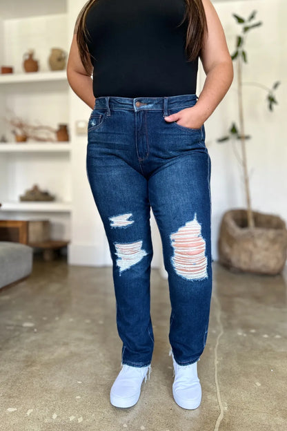 Plus size model wearing Wynna High Waist Straight Jeans, heavy distressing and raw hem
