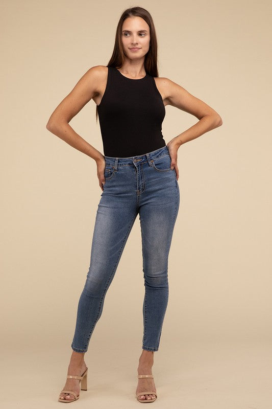 Sleeveless bodysuit in black with a boat neckline, padded bodice, and removable bra pads for adjustable comfort.