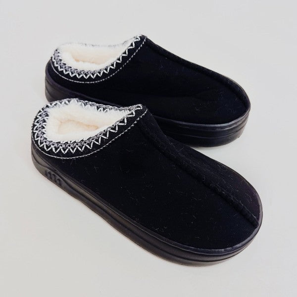 Black Cozy Cloud Slippers side view showing plush lining and soft suede texture.