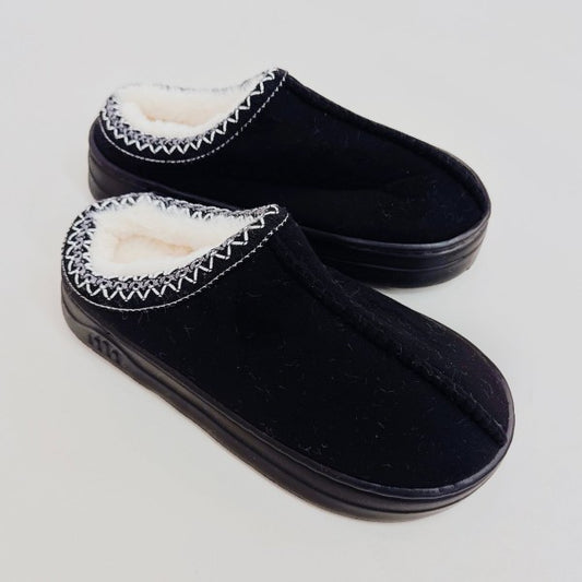 Black Cozy Cloud Slippers side view showing plush lining and soft suede texture.
