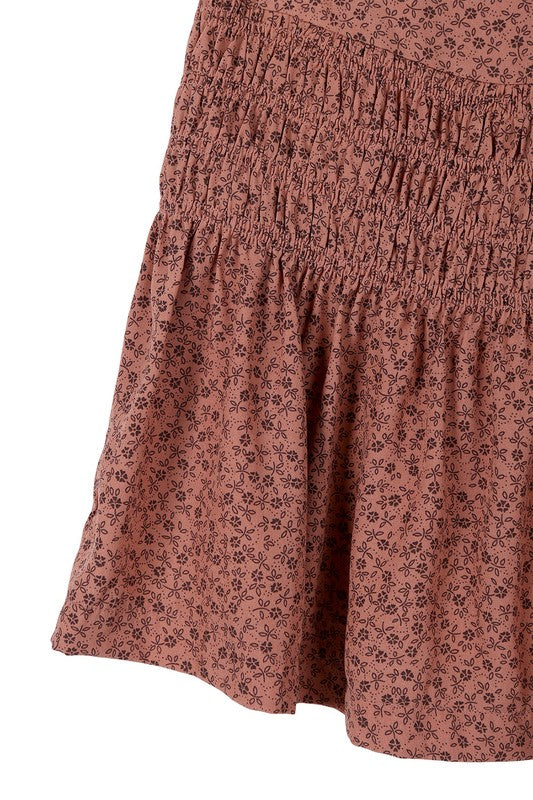 Brown floral smocked skirt with pleats, side zipper, and lining for coverage.