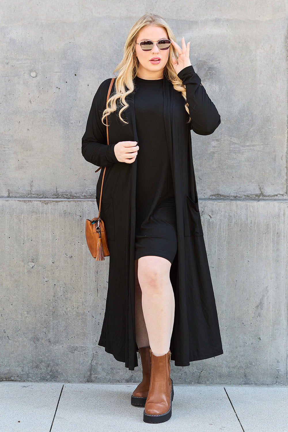 Black open-front long-sleeve cover-up with a flowy design and pockets, perfect for layering on breezy days.