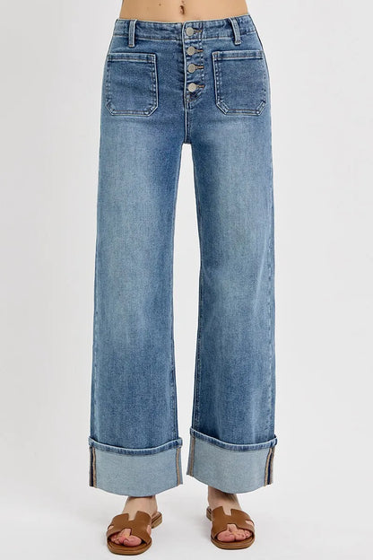 Close-up front view of Asher high rise jeans highlighting button fly closure, front patch pockets, and medium wash wide leg style by RISEN