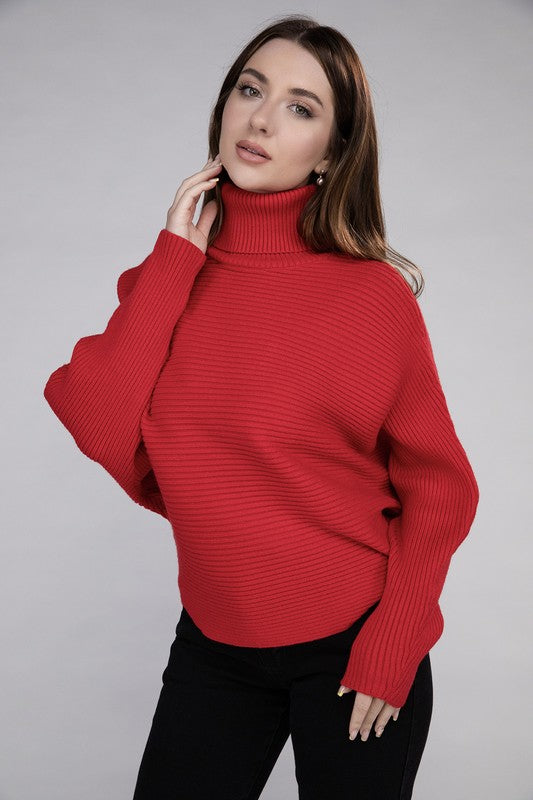 Ruby loose fitting turtleneck sweater, with ribbed knit texture, dolman sleeves, and raw hem detailing.