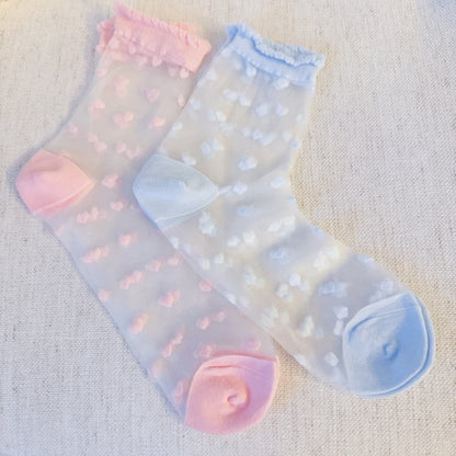 Flat lay of pink and blue Sweet Hearts Sheer Socks with playful heart motif.