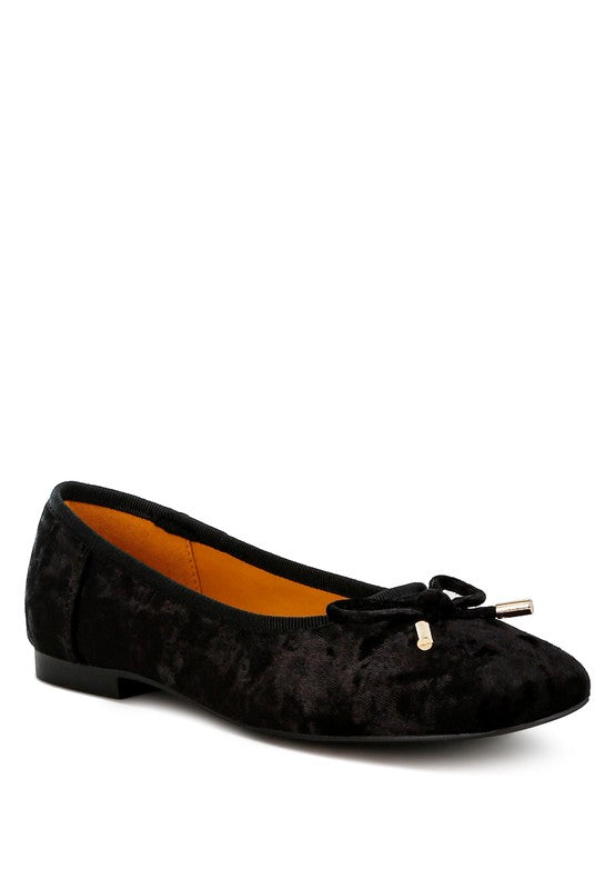 Black velvet ballerina flats with a closed square toe, bow detail on the vamp, and cushioned insoles for comfort.