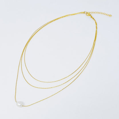 Flat lay of layered freshwater pearl pendant necklace with extender clasp