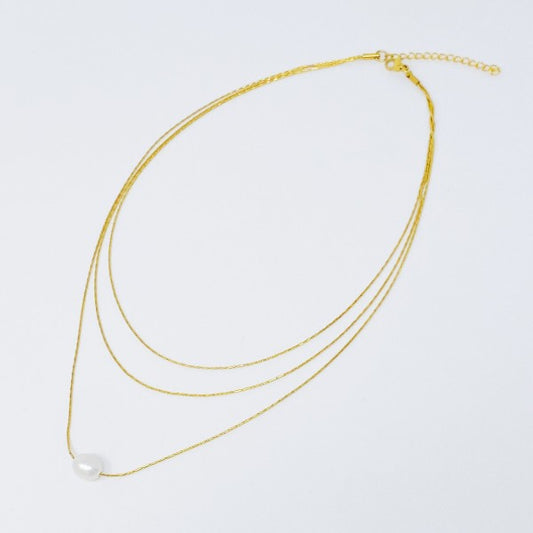 Flat lay of layered freshwater pearl pendant necklace with extender clasp