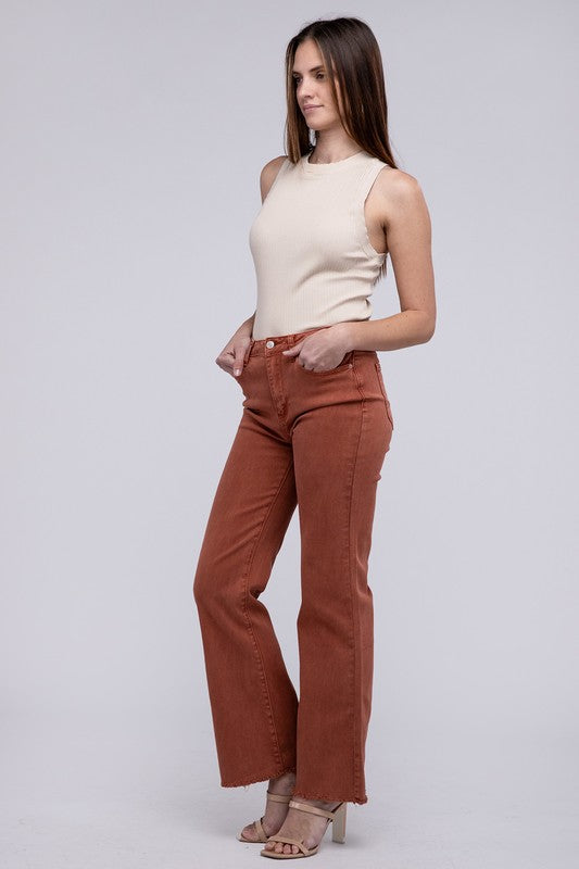 Rust acid-washed straight wide-leg pants featuring a frayed cutoff hem, zip fly closure, and a relaxed fit. Made with stretchy fabric for comfort and a unique vintage-inspired look.