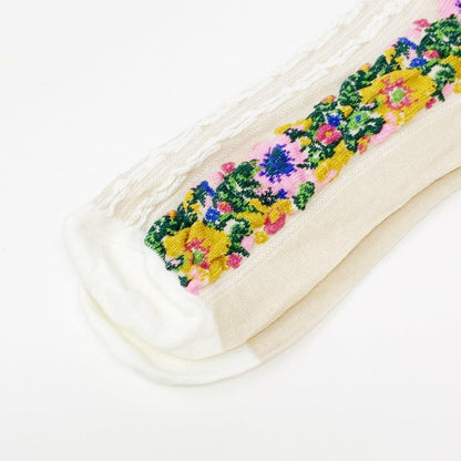 Close-up of colorful embroidered flowers on white Noble Floral Beauty Socks.