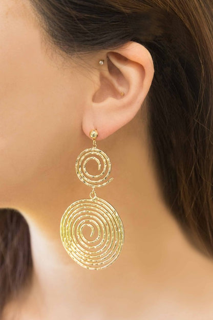 Navi Swirl Drop Earrings gold spirals worn by woman