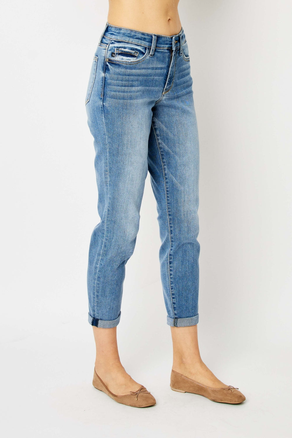 Mid-rise slim fit jeans with cuffed hems and a zip fly. Medium wash, highly stretchy fabric.