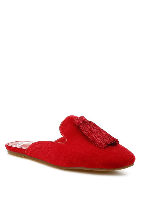 Red mules with velvet upper and tassel detail.