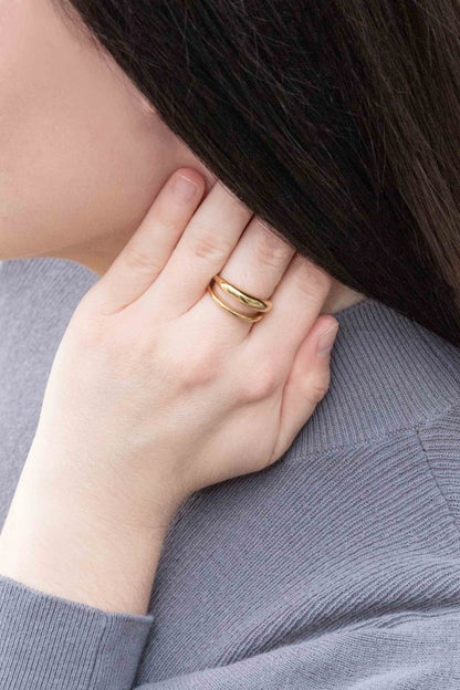 Double Layer Ring styled on hand near face with chic shine.