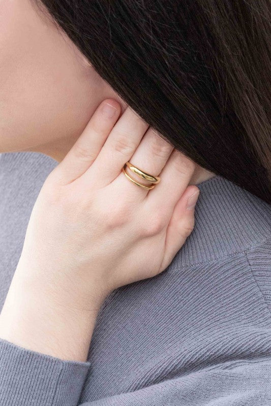 Double Layer Ring styled on hand near face with chic shine.
