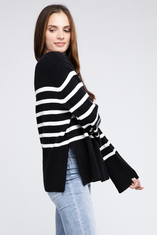 Black oversized sweater with a ribbed hem and striped pattern, featuring a round neckline and long sleeves.