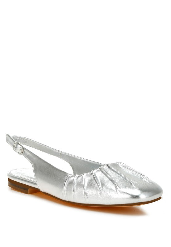 Metallic pleather flat slingbacks with a square closed toe, adjustable pin buckle strap, and cushioned insole, available in silver.