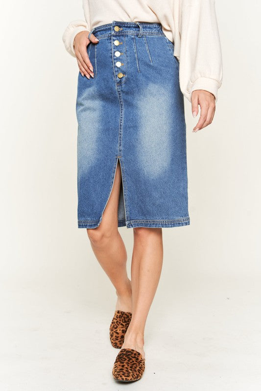 Denim button-down midi skirt with a front slit, belt loops, and back pockets. Features a high waist with an elasticized waistband in the back.