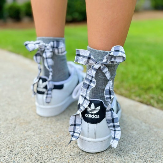 Woman wearing grey Plaid Ruffle Bow Socks styled with sneakers and chic bow detail.