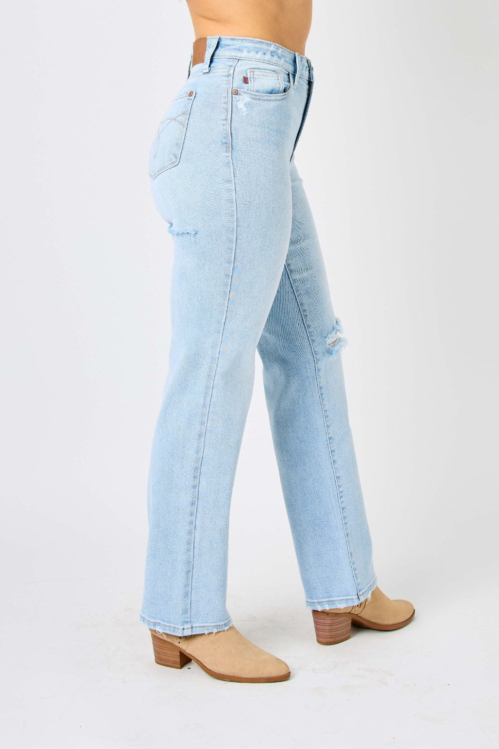 High waist distressed straight jeans in light wash. Slightly stretchy with a zip fly closure.