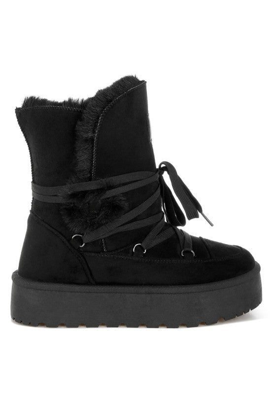Side angle of Black Noaya Chunky Faux Fur Snow Boots showing chunky lug sole and flatform heel.